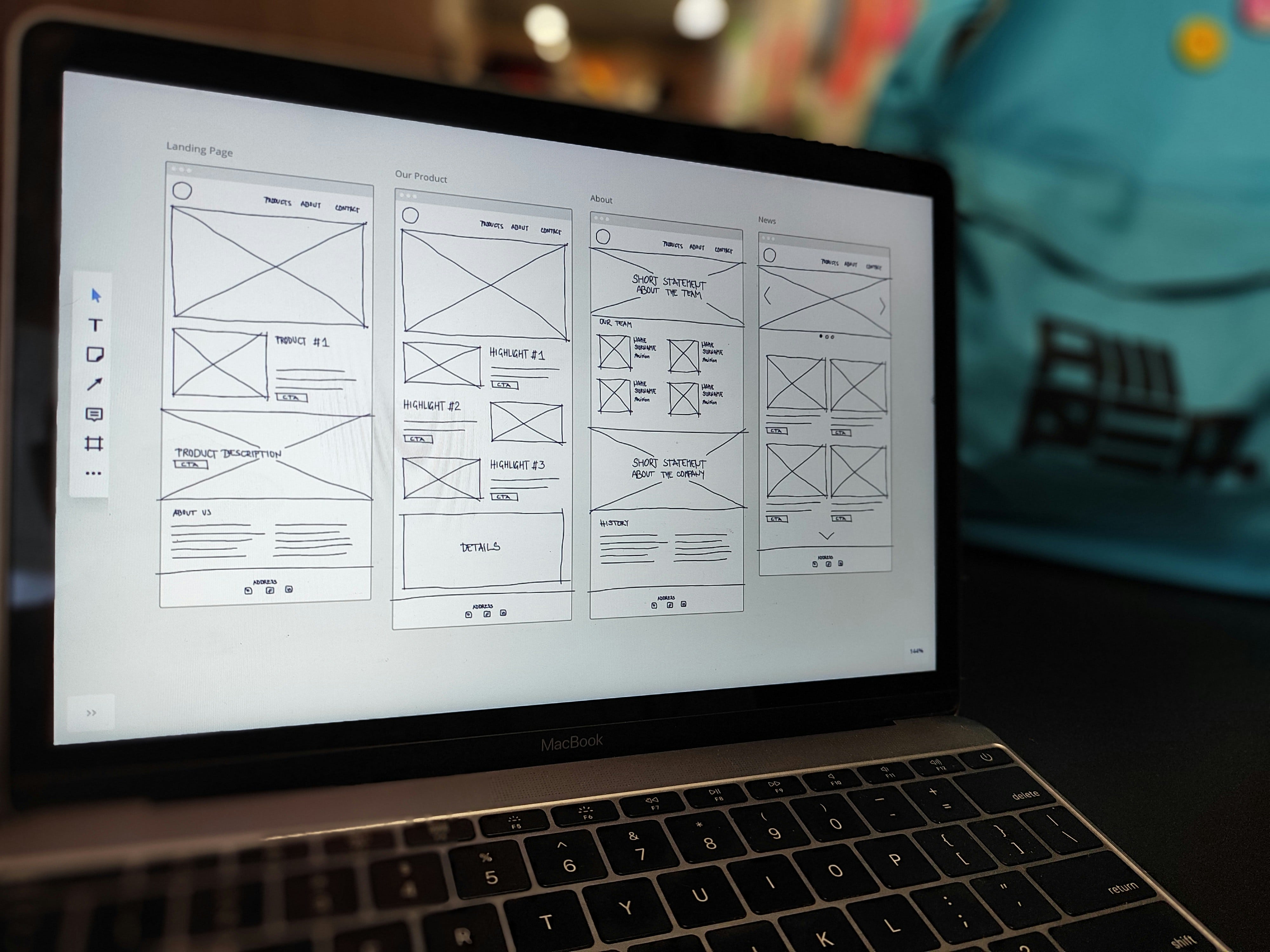 A laptop screen displaying project wireframing phase